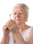 Old woman preparing syringe for making insulin injection