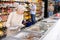 Old woman purchaser choosing frozen fish in big supermarket