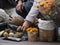 The old woman puts mushrooms on the street market in autumn