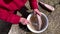 old woman's hands cleaning a frozen fish carcass