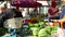 Old woman selling vegetables at her stand