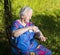 Old woman spraying insect repellent