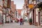 An old woman stand on the street of Celle town, Germany