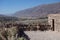 Old woman statue and the valley - pucara de tilcara / pre-Inca fortification - jujuy, argentina