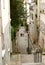 An old woman at a table in a deserted street near Montmarte