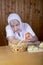 The old woman touches onions sitting