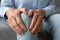 Old woman touching knee feeling pain suffering from osteoarthritis, closeup