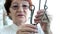 An old woman unravels a metal puzzle, coaches brain activity