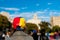 Old woman wearing hat with venezuelan flag and country name in Barcelona city main square during march for regime change