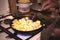 Old women`s hands stir fried potatoes with spoon in frying pan