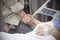 An old women Sick patient lying on bed holding her husband hand