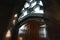 Old wood door with a small handle on red brick wall background, vintage window, rays of light