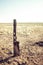 Old wood fence with fire damage on a flat prairie