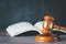 Old wood Judge Hammer with Law Book on the table wood background, Used for adjudication and Justice