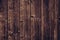 Old wood texture background. Brown shabby wooden fence. Dark brown dirty wood boards. Dilapidated plank timber surface, lumber, pa