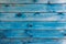 Old wood texture with a shabby blue paint. Top view, copy space