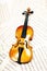 Old wood violin lying musical notes