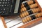 Old wooden abacus and electronic calculator