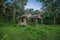 Old wooden abandoned cottage against sky