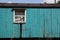 Old wooden abandoned wagon on the background of blue sky