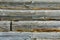 Old wooden background with horizontal boards, grey wooden wall of a dilapidated village house, close up