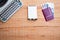 Old wooden background with typewriter, notepad, and passport with money