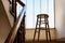 Old wooden Bar Stool in a Wooden Staircase with Handrailing in an Old house