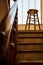 Old wooden Bar Stool in a Wooden Staircase with Handrailing in an Old house