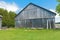 Old wooden barn against a blue sky.