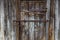 old wooden barn door with iron padlocks and rustes steel reinforcement bands