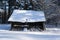 old wooden barn in the forest in winter