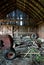 Old wooden barn full of junk and rusting tractor