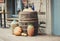 Old wooden barrels on which there are pumpkins and bottles.