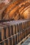 Old wooden barrels with wine in the ancient medieval cellars