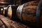 Old wooden barrels in wine cellar of winery, vintage oak casks in storage closeup. Concept of vineyard, viticulture, production,