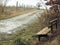 Old wooden bench along a quiet country road