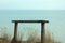 Old wooden bench on the hill over the sea.