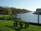 Old wooden bench on a riverbank in the fall season