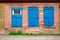 Old wooden blue window of slum house in Astrakhan, Russia