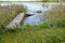 Old wooden boat filled with water at jetty