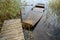 Old wooden boat filled with water at jetty