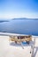 Old Wooden Boat on White roof in Thira Against The Aegean Sea and The Chain of Islands in Santorini