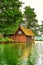 Old wooden boathouse under trees at Schwerin lake. Mecklenburg-Western Pomerania, Germany