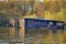 Old wooden boathouses with trees in the background