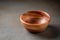 Old wooden bowl on a grey table