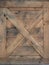 Old wooden box. selective focus on the X mark on a wooden door on a cowboy barn texture or background