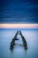 Old wooden breakwater at the beachat sundown,long time exposure photo