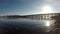 Old wooden bridge and calm waves and bright sunshine in northern norway