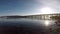 Old wooden bridge and calm waves and bright sunshine in northern norway