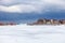 An old, wooden bridge crosses a section of frozen Georgian Bay waterfront in Collingwood